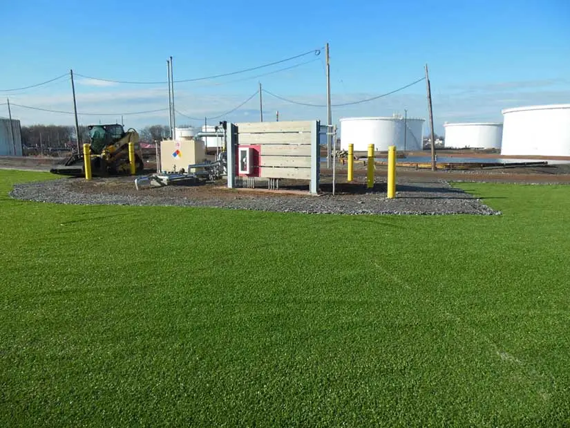 Work site with silos in background