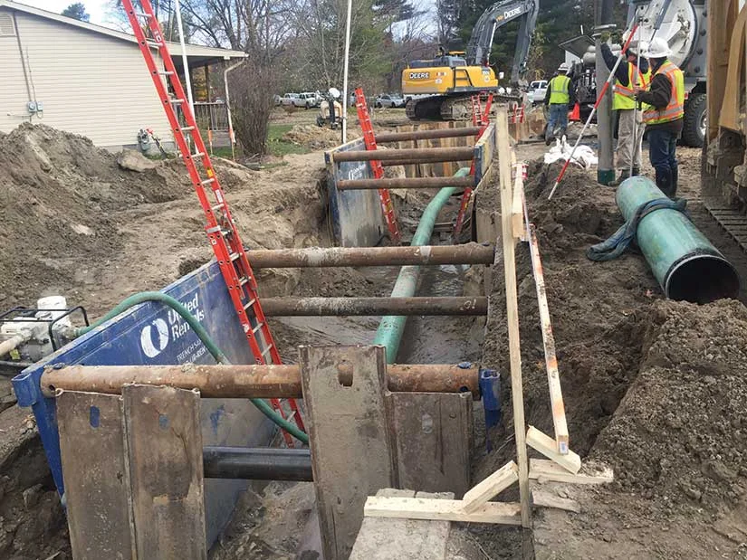 Workers putting pipeline construction in the ground