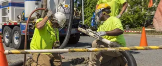 Techs gauging a well