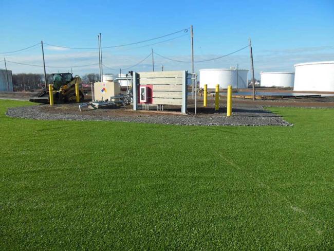 Work site with silos in background
