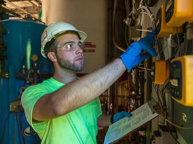 OM&M Technician performing maintenance checks on industrial GWTP