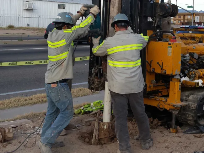 Men installing drill