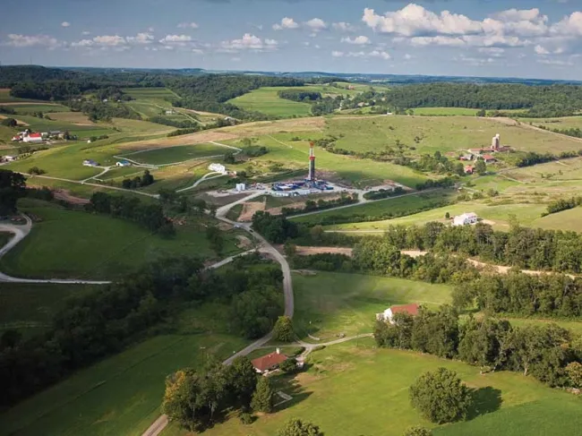 Aerial shot of green land and well