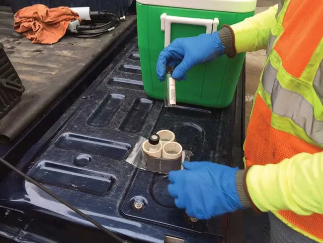 Technician with sample bottle